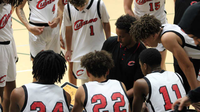 Cleveland coach Dagem Asfaw leads the huddle during a game at the Classic at Damien